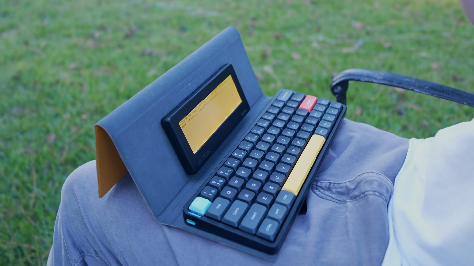 BYOK magnetically attached to the open flap of a NuPhy Air folio, forming a clamshell