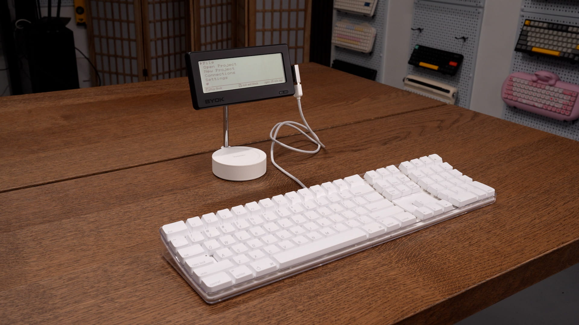 BYOK on a white desk stand behind a vintage white Apple keyboard