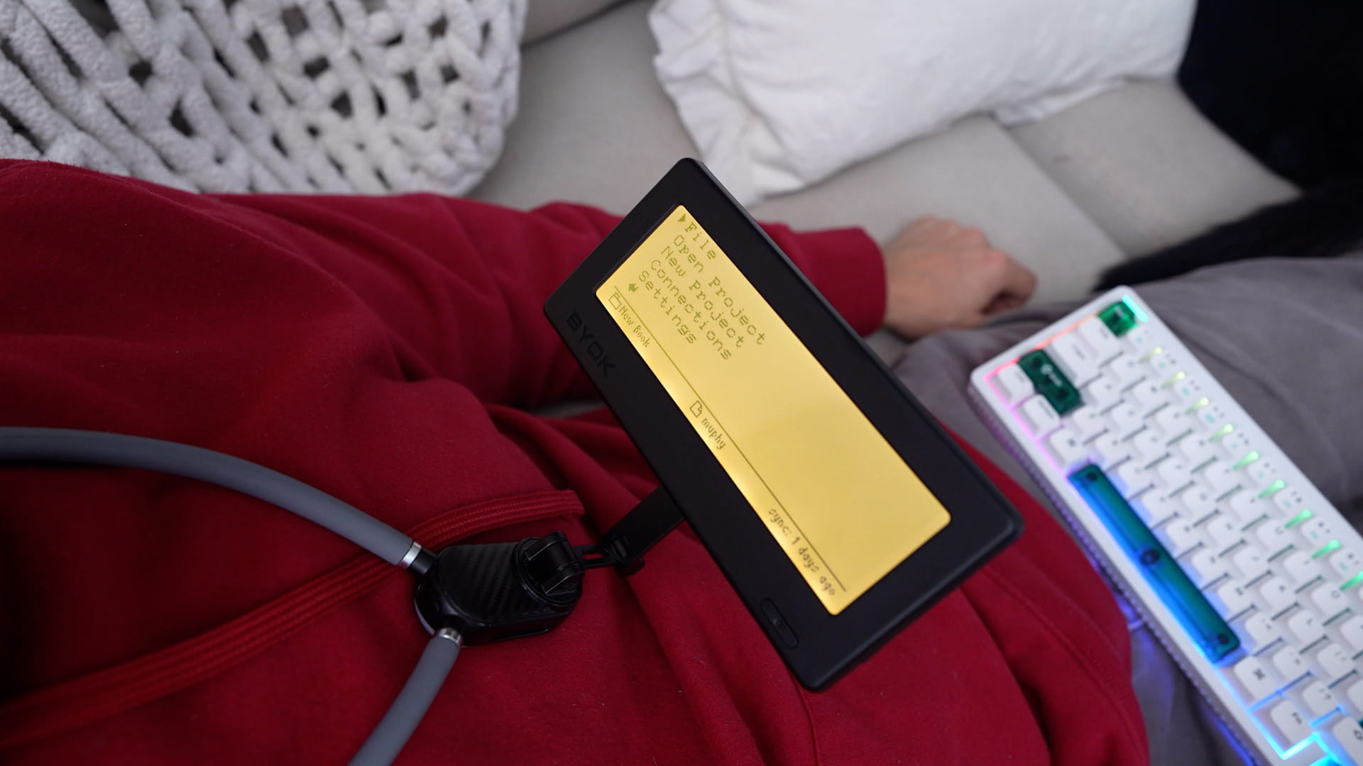 BYOK held in front of a writer by a wearable neck mount
