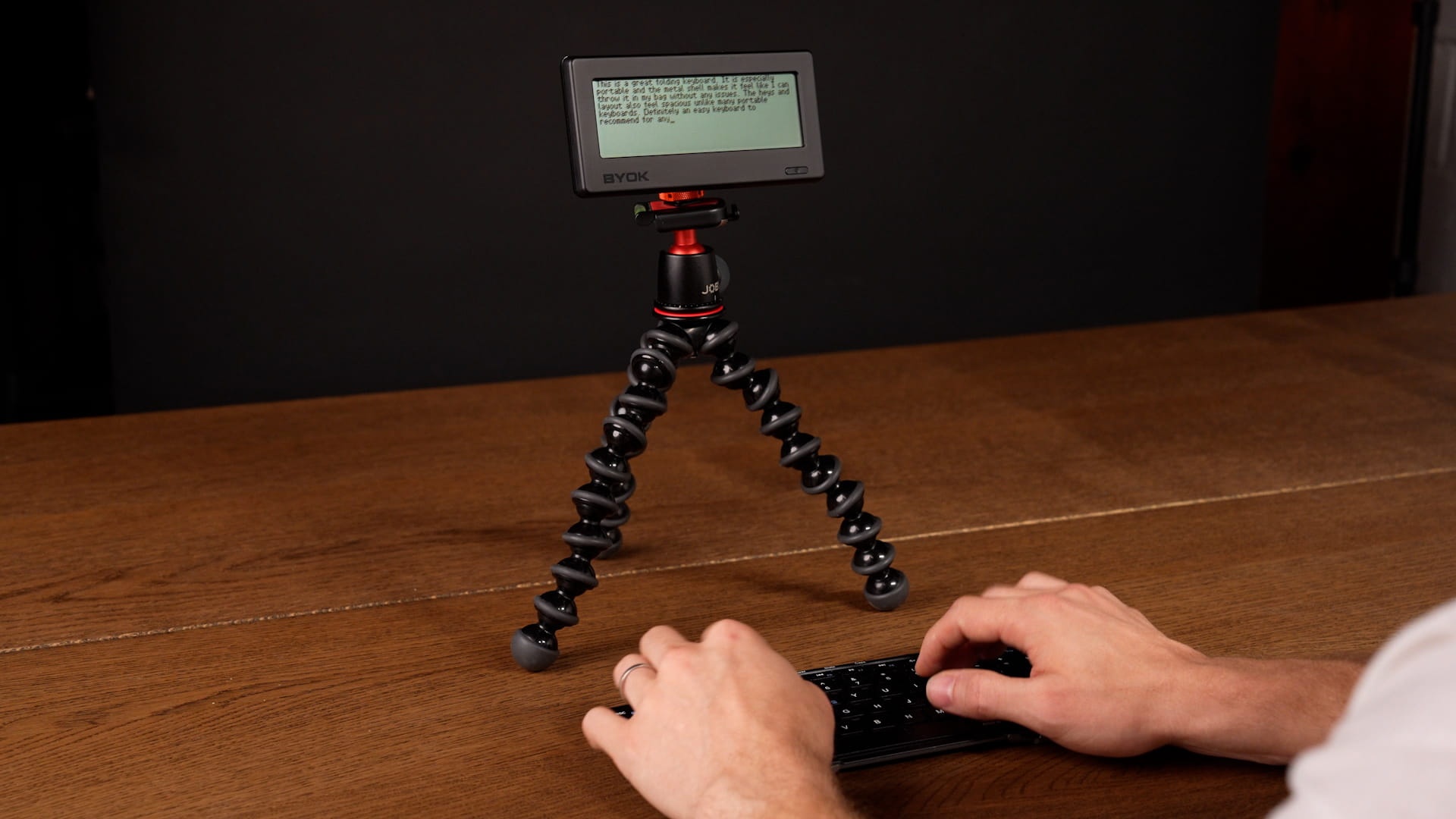 BYOK mounted on a Joby flexible tripod with a magnetic mount beside a folding keyboard