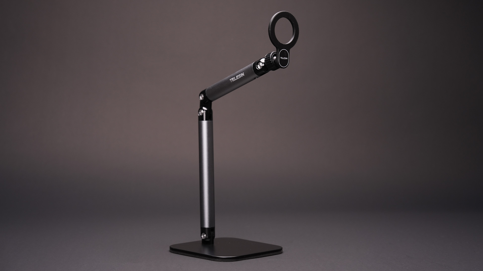 Tall adjustable magnetic desk stand shown on its own against a dark background