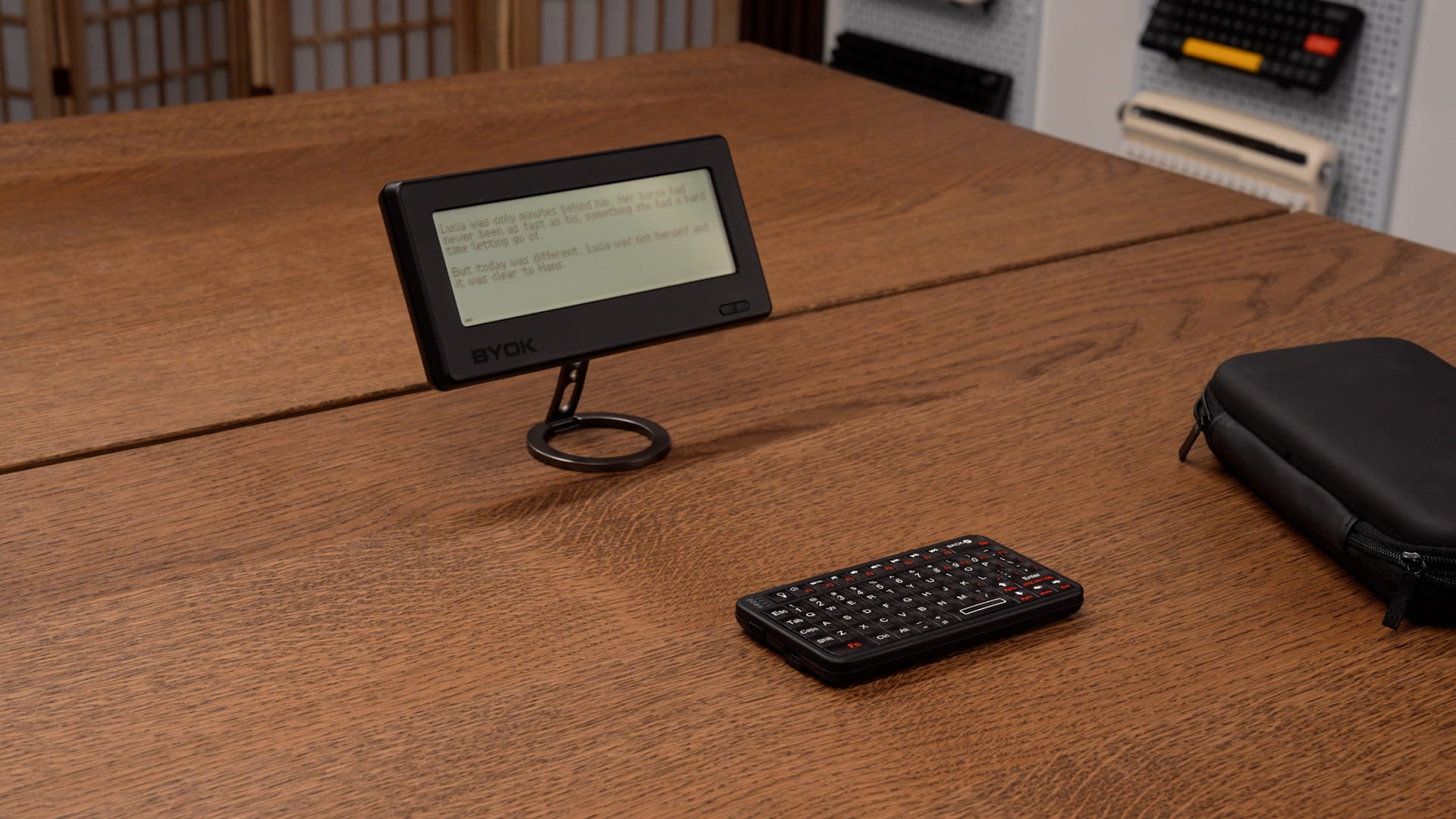 BYOK standing on a magnetic ring stand beside a small handheld keyboard