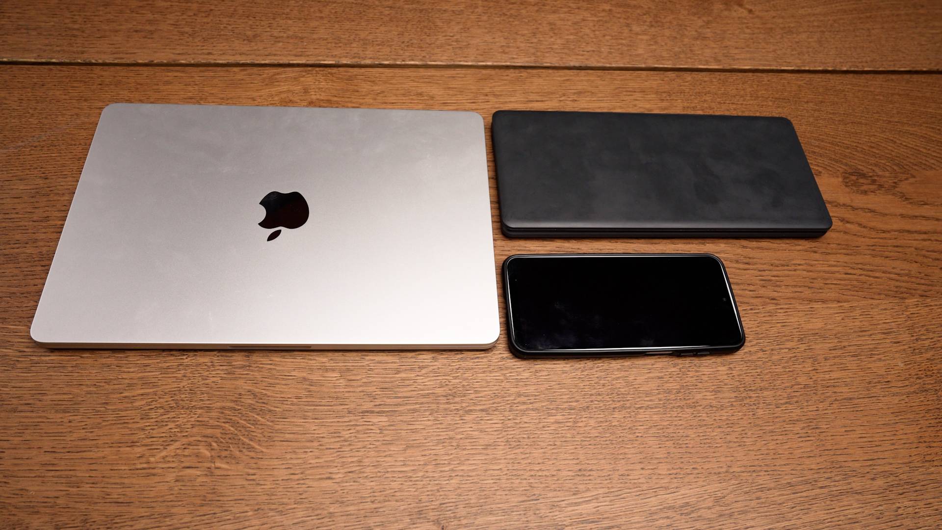 Pomera folded next to a phone for scale