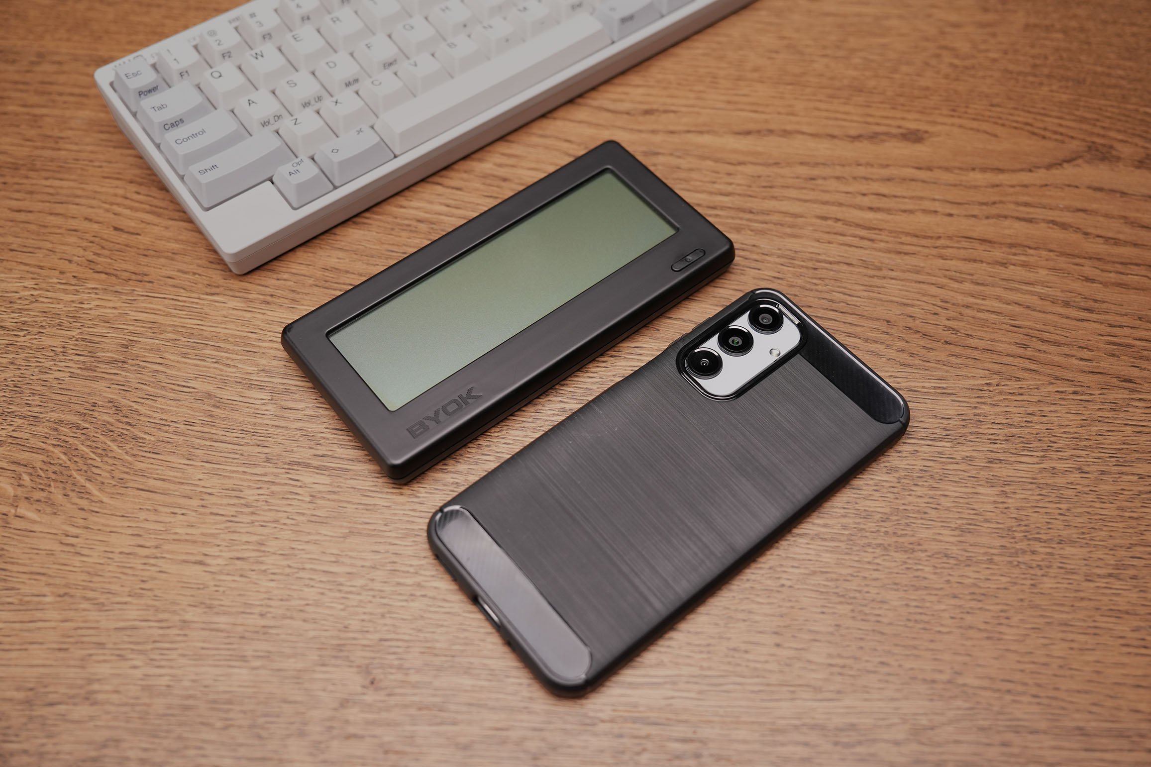 BYOK writing device shown next to a smartphone for size comparison