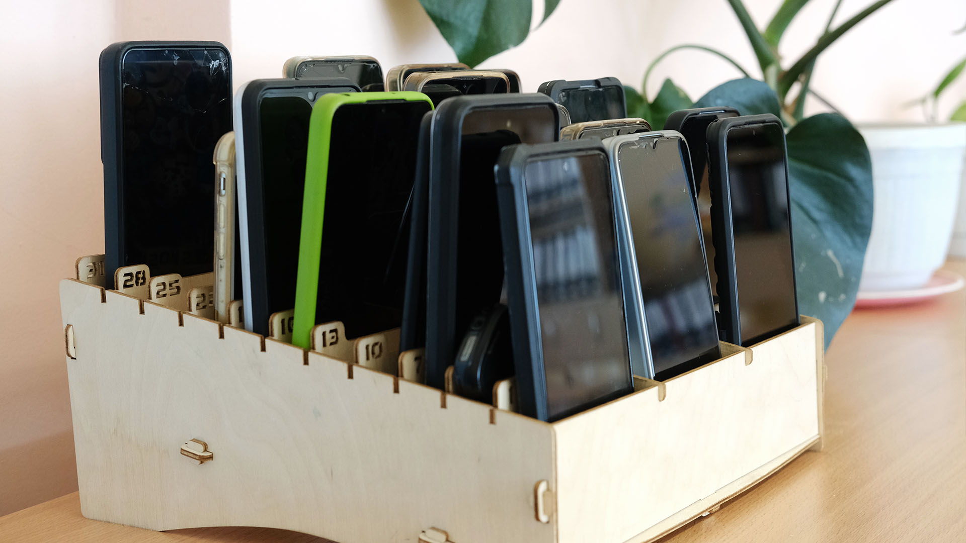 Collected smartphones at the front of a classroom